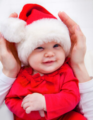 Portrait of Christmas baby is lying on mother’s hands