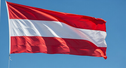 Proud Austrian flag waving gently against clear blue sky, symbolizing national pride and vibrant European culture on a sunny day, perfect for travel