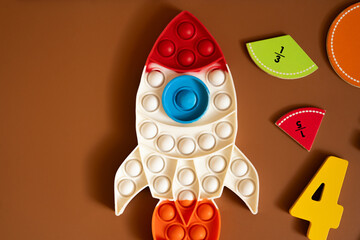 Colorful learning materials arranged on  brown surface for educational activities with shapes and numbers