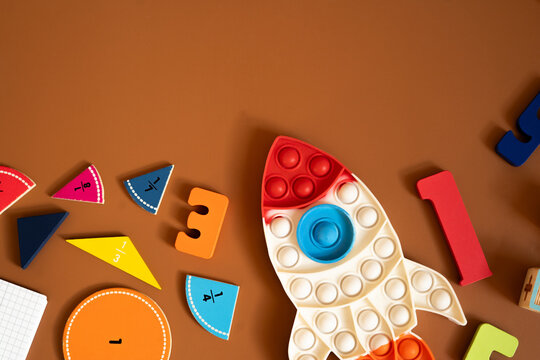 Colorful learning materials arranged on a brown surface for educational activities with shapes and numbers