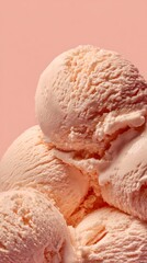 Stacked scoops of peach ice cream against a soft pink backdrop, highlighting the creamy texture and vibrant color, ideal for summer treats and dessert inspiration