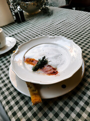 Delicious gourmet dish served on a white plate in a charming cafe setting