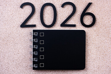 New year goals 2026. 2026 resolutions list with notebook on table. Resolutions, plan, goals, action, checklist, idea concept. New Year 2026 resolutions, copy space