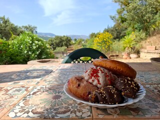Breakfast in the garden, buns in plate, village.