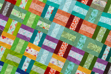 A patchwork quilt with many different colored squares