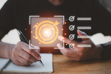 Business planning concept and strategic goal setting and with a businessman pointing at a target icon and checklist. Ideal for success, productivity, project execution and leadership content.