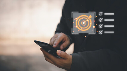 Business planning concept and strategic goal setting and with a businessman pointing at a target...