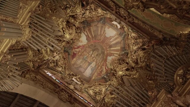 ornate baroque ceiling with golden carvings and religious painting inside s&eacute; de braga cathedral portugal
