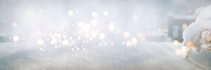 Bright winter background with snowflakes and festive bokeh lights on pine branches. Christmas...