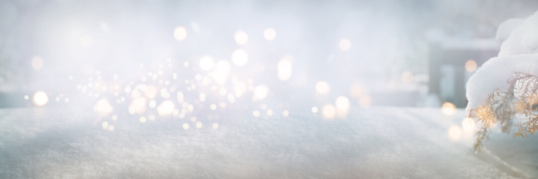 Bright winter background with snowflakes and festive bokeh lights on pine branches. Christmas greeting card with space for text.