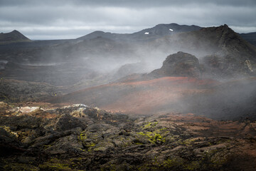 Dark lava fields and smoking earth