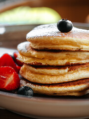 Pancakes with berries and chocolate sauce