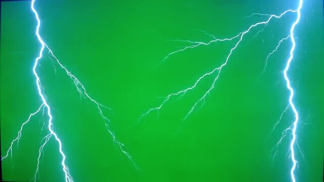 Powerful electric lightning bolt strike creating bright white energy discharge with multiple branches on a chroma key green screen background for easy compositing.

