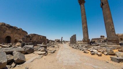 Fototapeta premium Ancient Ruins with Stone Columns Under Blue Sky