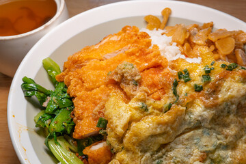 angle view deep fried chicken fillet and fried egg rice with pork tripe and red date soup at horizontal composition