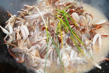 home-style stir-fried crab in a large wok