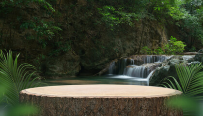 wood stump table top podium with outdoor waterfall tropical forest nature background landscape.Natural water mineral product present placement pedestal wooden stand display.jungle paradise concept.