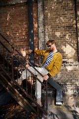 Fototapeta premium Stylish redhead man enjoying an autumn day in the city with trendy fashion choices