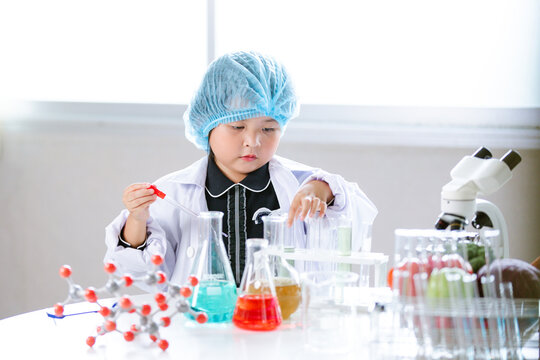 Asian little cute girl students. Girl doing science experiment science classroom. Education research and development concept learning kids.