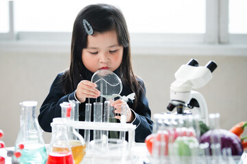 Asian little cute girl students. Girl doing science experiment science classroom. Education research and development concept learning kids.