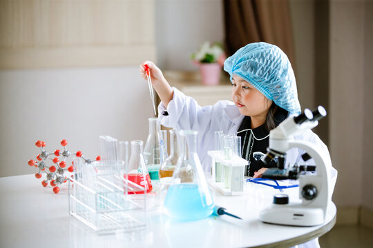 Asian little cute girl students. Girl doing science experiment science classroom. Education research and development concept learning kids.