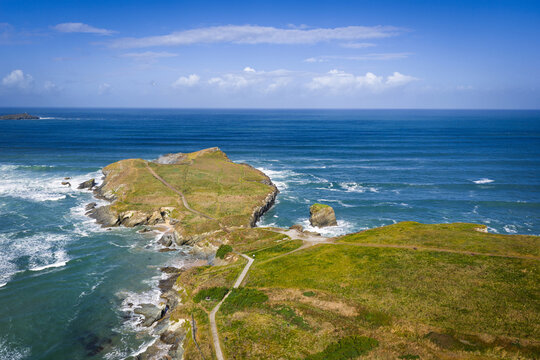 Surf and waves Mawgan Porth north Cornwall England near Newquay and south of Porthcothan and Treyarnon on a summer day with blue sk