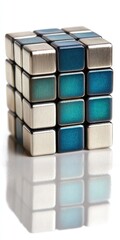 Obraz premium A precisely arranged cube of metal squares, showcasing a gradient of teal and gray tones, sits on a plain white background, reflecting perfectly.