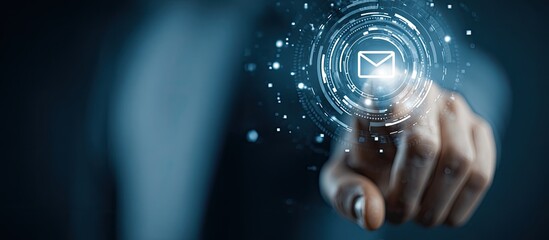 A hand points to a digital email icon.  A light,  holographic email symbol is projected and  hovered over by a fingertip.  Dark background