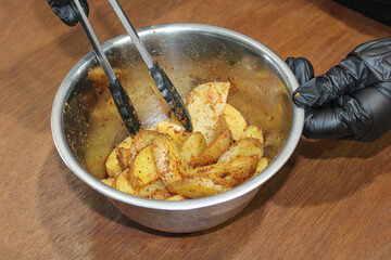 Spicy Seasoned Potato Wedges in Mixing Bowl