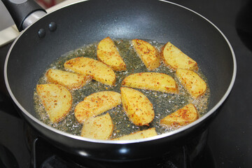 Potato Wedges Deep Frying in Hot Oil Pan