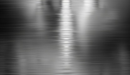 A grayscale image showing a brushed metal texture with varying shades of gray creating a vertically oriented, reflective surface