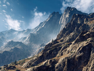 Majestic mountain landscape under a bright blue sky with wispy clouds, rocky terrain adorned with patches of greenery and rugged slopes stretching into the distance.