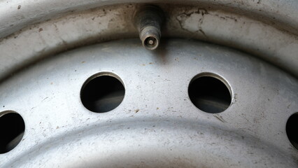 Close-up of a car tire with no valve cap. DIY car repairs at home.