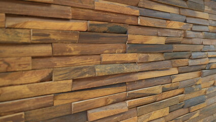 Side view of stacked wooden blocks forming a wall, showing natural wood texture.