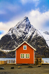 Red Cabin by Snow-Capped Mountain in Arctic Landscape