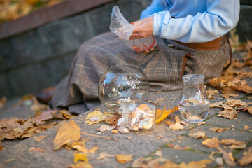 women's hands hold a container of water in which fish are swimming