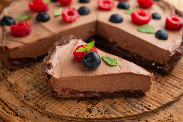 Chocolate mousse cake with red berries, blueberries, and raspberries.