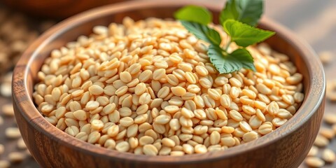 Obraz premium Close-up of raw buckwheat groats in a wooden bowl, rustic, background