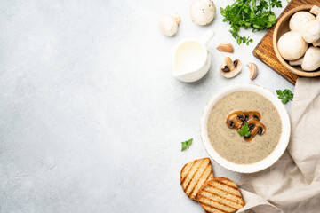 Mushroom soup puree on white kitchen table.