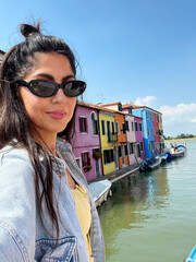 Beautiful smiling traveler  woman   in Burano ,Italy