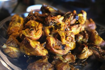 A delicious serving of golden-brown fried chicken pieces, seasoned with aromatic spices and served on a platter for a savory meal