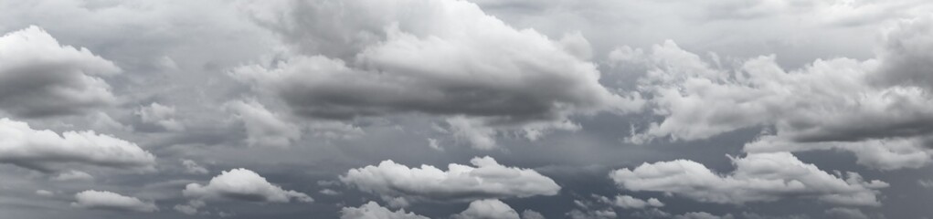 Dramatic clouds cover the sky above a tranquil landscape during an impending storm in the afternoon