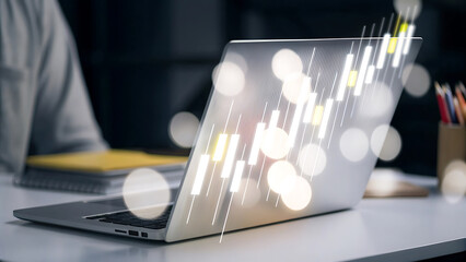 Laptop desk with holographic stock market chart for financial analytics