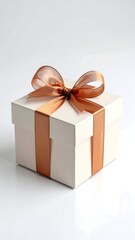A pristine white gift box, tied with a light copper ribbon