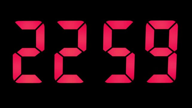 Digital clock with large red digits counting down seconds to 23:00, close-up.
