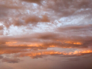 Evening sky. Summer, the sun is already at the horizon, softly illuminating the clouds, a beautiful landscape of the sky,