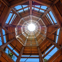 Fototapeta premium Wooden tower, sun rays, interior view