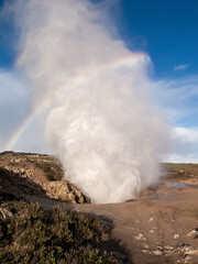 Blowhole geyser steam erupting with rainbow in asturias