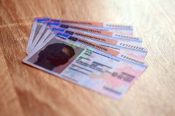 German Permanent resident specimen cards lies on wooden table. Aufenthaltstitel