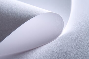 Close-up of creased white paper.  Soft folds and textures are emphasized